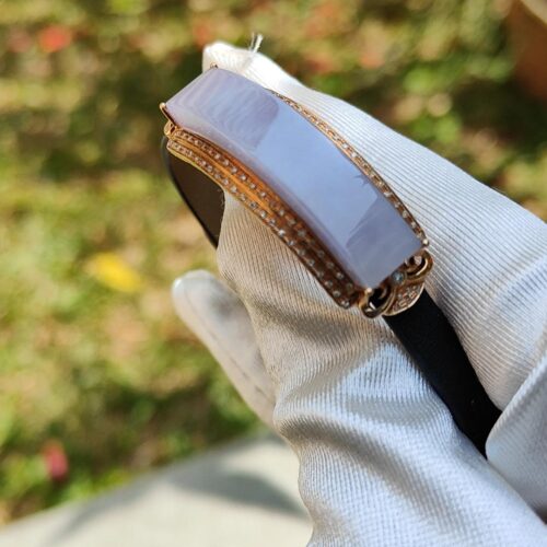 a hand wearing a glove holding a ring