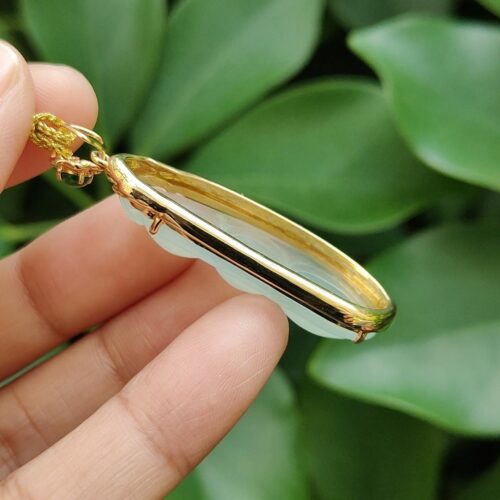 a hand holding a necklace