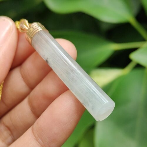 a hand holding a white crystal