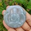 Una mano sosteniendo un colgante de jade.