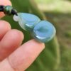 a hand holding a bead