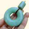 a hand holding a green round object