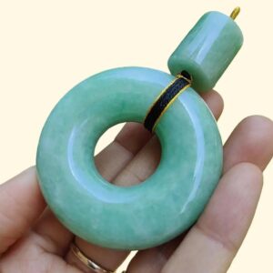 a hand holding a green round object