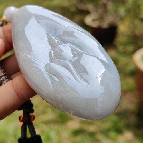 a hand holding a white stone