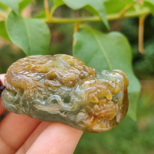 a hand holding a small stone
