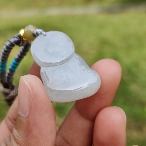 a hand holding a small white object