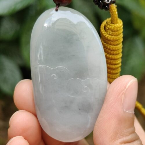 a hand holding a necklace