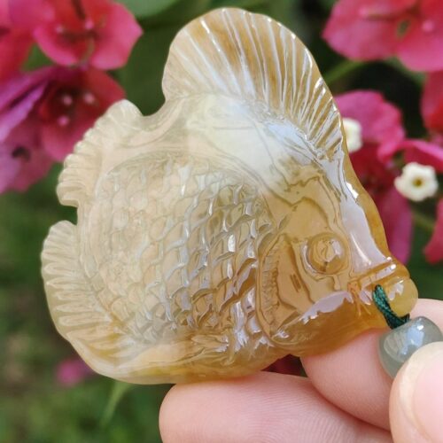 a hand holding a stone fish