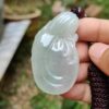 Una mano sosteniendo un colgante de jade.