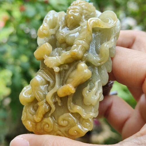 a hand holding a carved stone