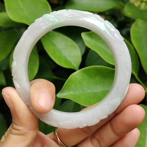 a hand holding a white circular object