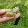 a hand holding a green object