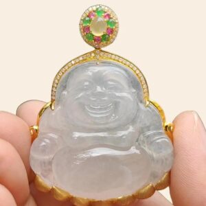 a hand holding a jade buddha pendant