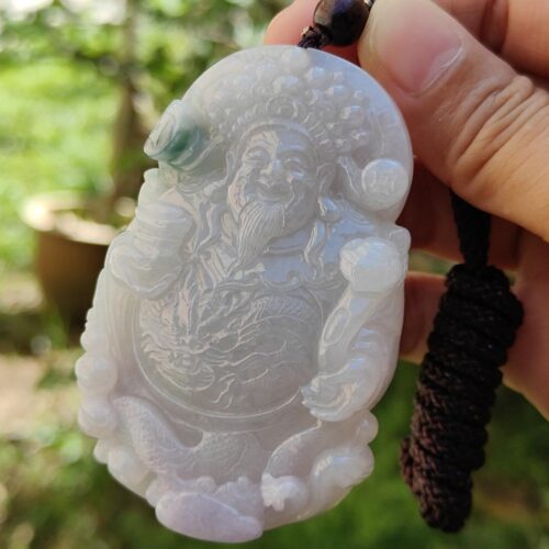 Una mano sosteniendo un colgante de jade.