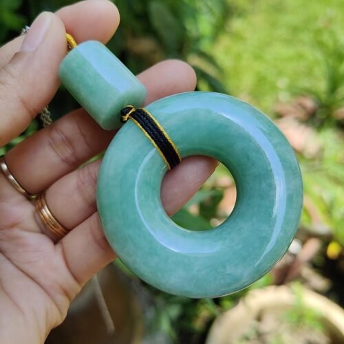 a hand holding a green round object
