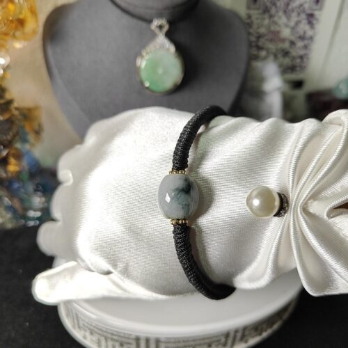 a hand with a bracelet on a mannequin