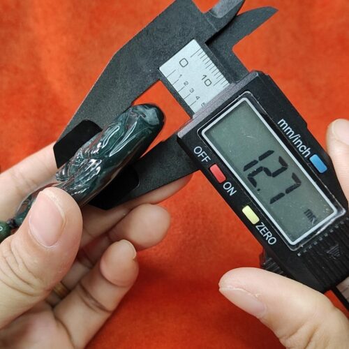 a person measuring a piece of food