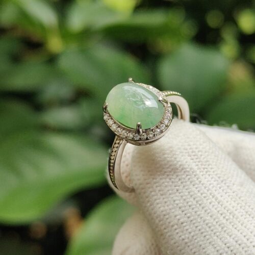 a hand wearing a white glove with a ring