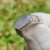 a hand wearing a white glove with a large stone ring