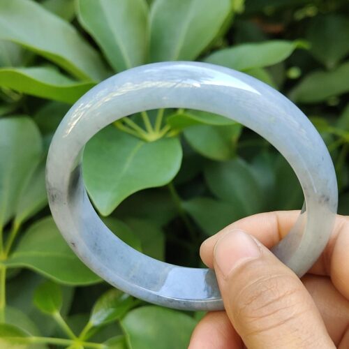 a hand holding a round bracelet