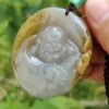 a hand holding a jade necklace