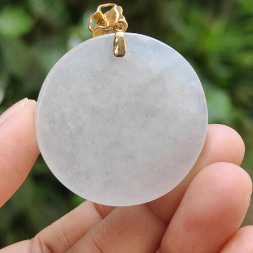 a hand holding a white round object