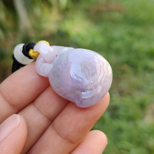 a hand holding a purple stone