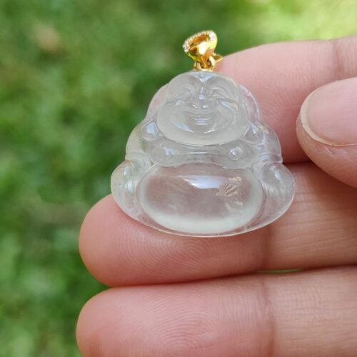 a hand holding a small glass object