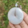 a hand holding a white round object