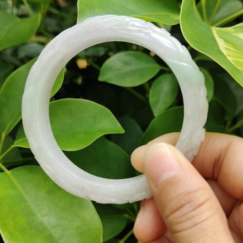 a hand holding a white circular object