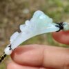 Una mano sosteniendo una pulsera de jade
