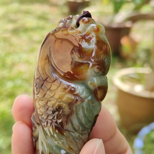 a hand holding a stone object