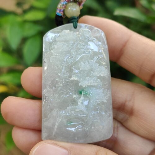 a hand holding a necklace