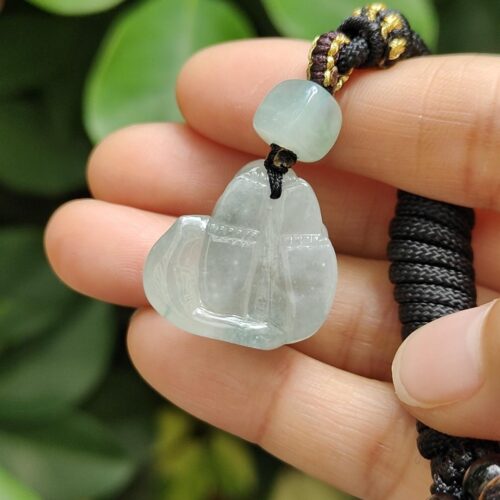 a hand holding a necklace