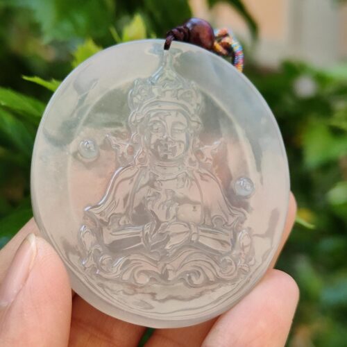 a hand holding a round object with a picture on it