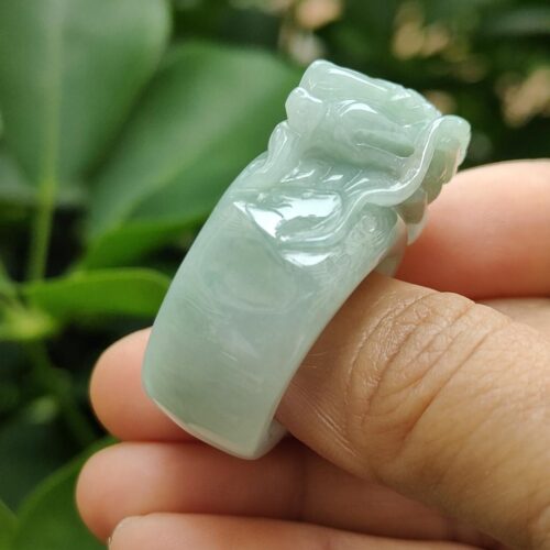 a person holding a jade ring