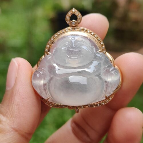 a hand holding a jade pendant