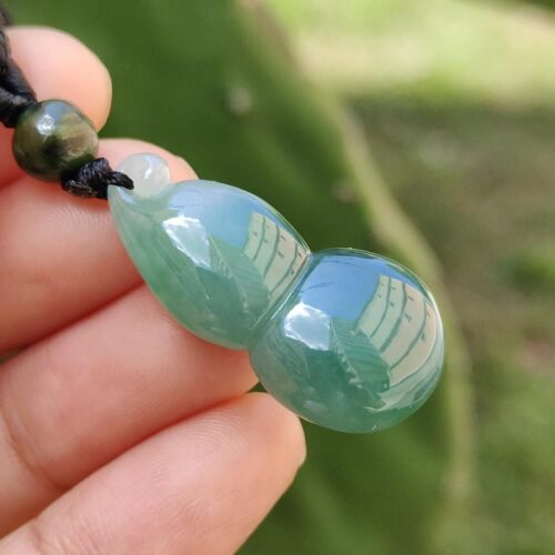 a hand holding a necklace