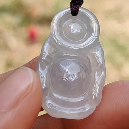 a hand holding a clear plastic object