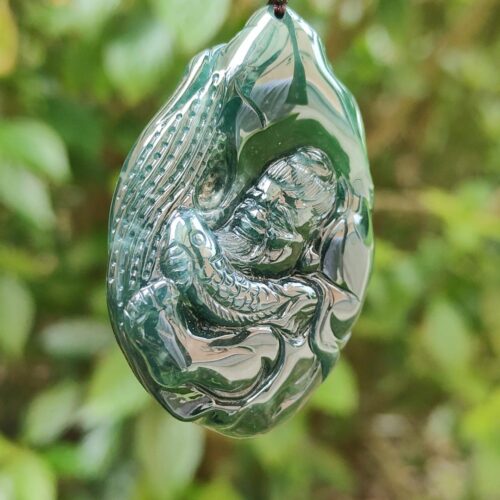 a green stone with a lizard on it