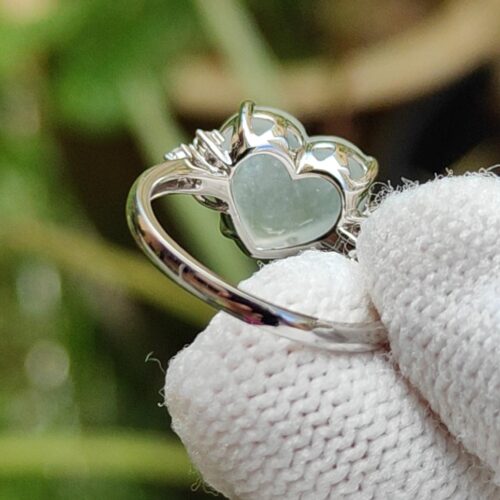 a hand wearing a glove holding a ring