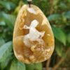 a stone pendant with a figure on it
