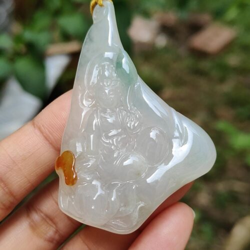 एक हाथ में जेड पेंडेंट थामे हुए
