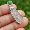 a hand holding a pendant