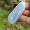 a hand holding a blue stone