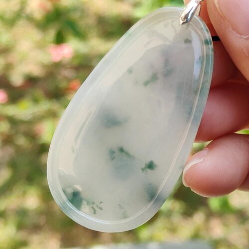 a hand holding a pendant