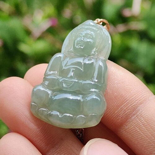 a person holding a jade pendant