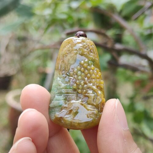 a hand holding a small green object