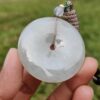 a hand holding a round white object