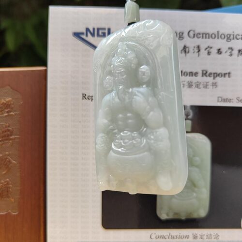 a jade pendant with a person in the middle
